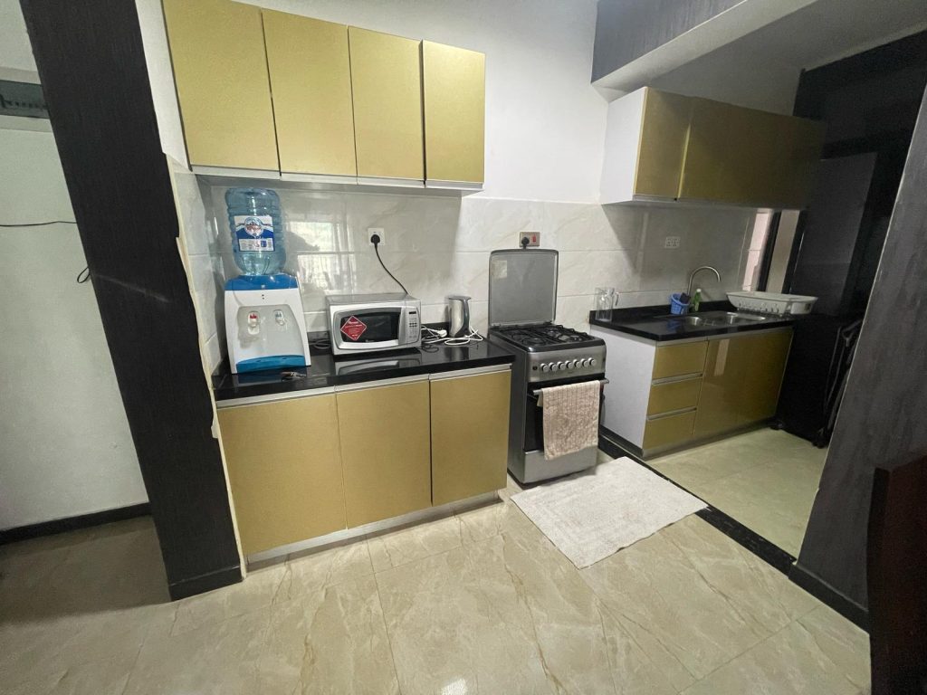 open plan kitchen fitted with appliances at cheap serviced 2 bedroom apartment in Nairobi
