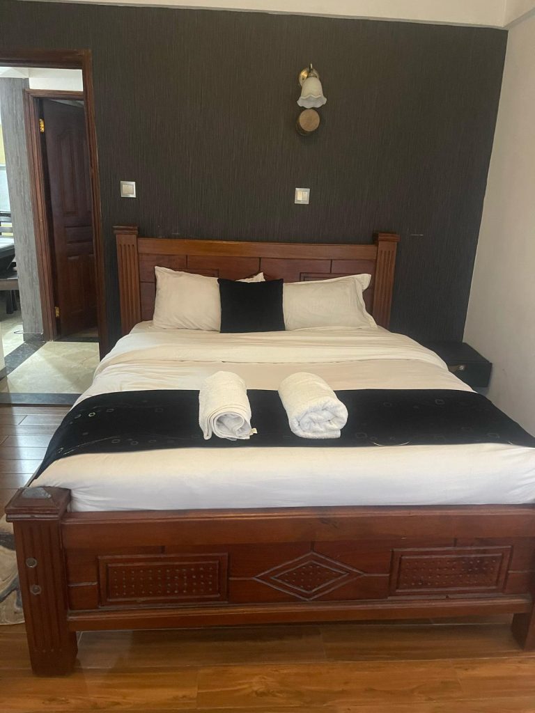 second bedroom with a queen sized at cheap serviced 2 bedroom apartment in Nairobi