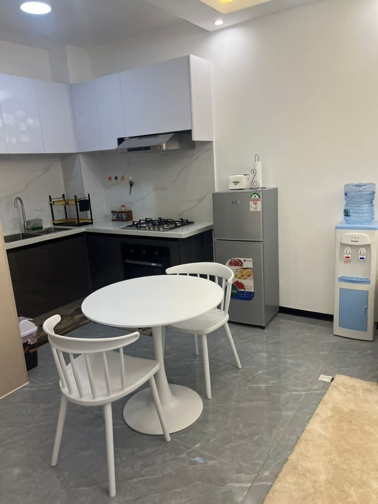 Dining area and a fiited open plan kitchen with applainces in Serviced Apartment for Foreigners in Nairobi
