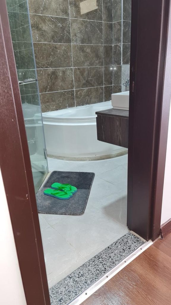 A modern bathroom with a bathtab abd cubicle shower in the Serviced and Furnished 3 Bedroom Apartment Nairobi