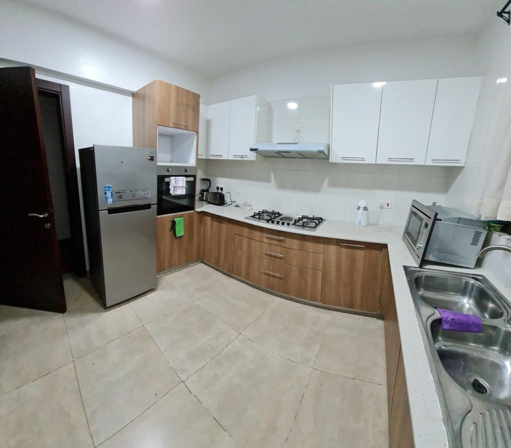 A large modern open plan kitchen fitted with appliances at Serviced and Furnished 3 Bedroom Apartment Nairobi
