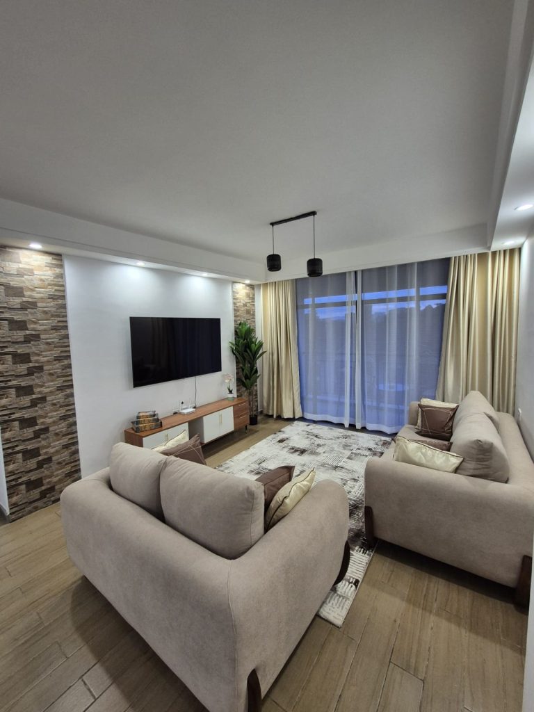 Spacious sitting room with a large smart TV and elegant interior decor – Serviced Furnished Apartment in Westlands Nairobi.
