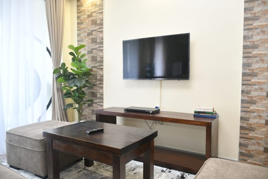 well lit sitting area of the Short Let Furnished Apartment in Westlands Nairobi with a smart tv
