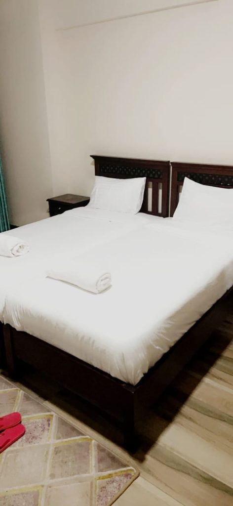 Closer view of the bedroom with a queen sized bed in Queen sized bed and large windows letting natural light in -Serviced 2 Bedroom Apartment for Booking in Nairobi