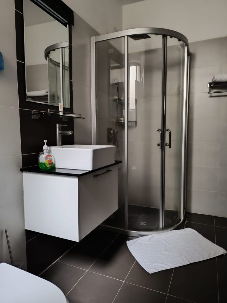 Cubicle shower and modern sink in the bathroom – Serviced 2 Bedroom Duplex Apartment in Nairobi