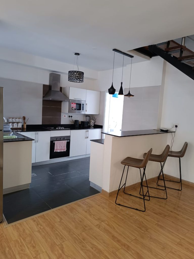 Modern open plan kitchen with island setup – Serviced 2 Bedroom Duplex Apartment in Nairobi