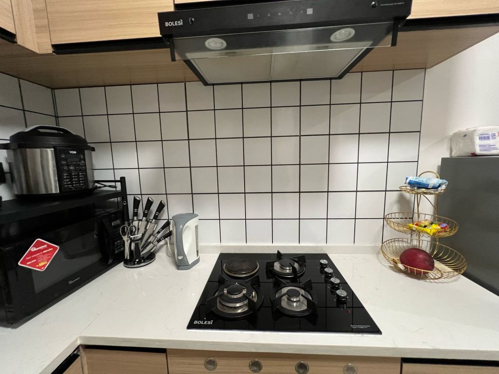 Well-ventilated kitchen at Ruaka furnished daily and monthly rental in Nairobi featuring a sleek hood and electric cooker.