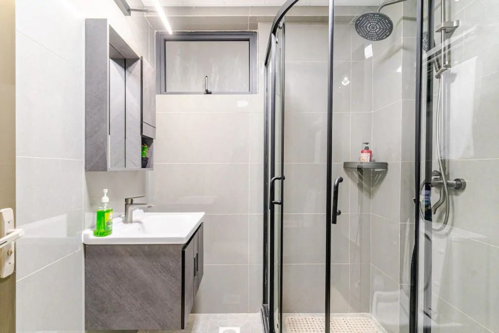 Cubicle shower with a modern sink and tiled finish – Furnished 3 Bedroom Apartment Riverside Nairobi