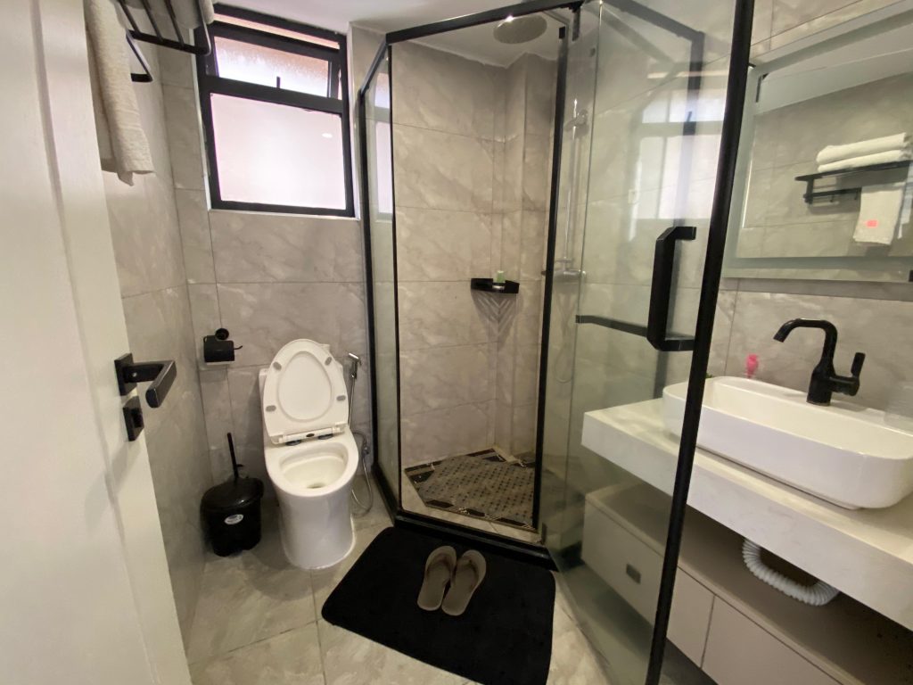 Ensuite bathroom with cubicle shower, toilet, and a classic sink in a fully furnished 2 bedroom master ensuite.