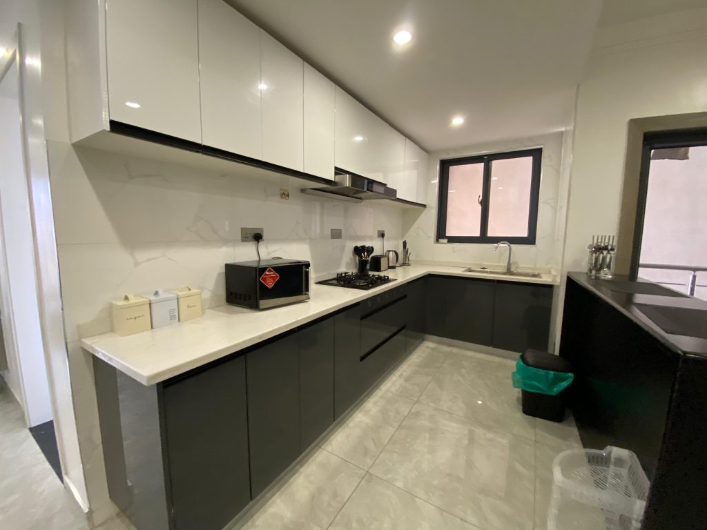 Open plan kitchen in a fully furnished 2 bedroom master ensuite featuring fitted appliances and modern finishes.