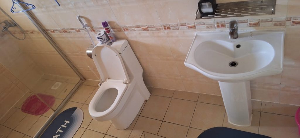 Contemporary bathroom with modern toilet and sleek sink design – Luxury 3 Bedroom Serviced Apartment in Nairobi