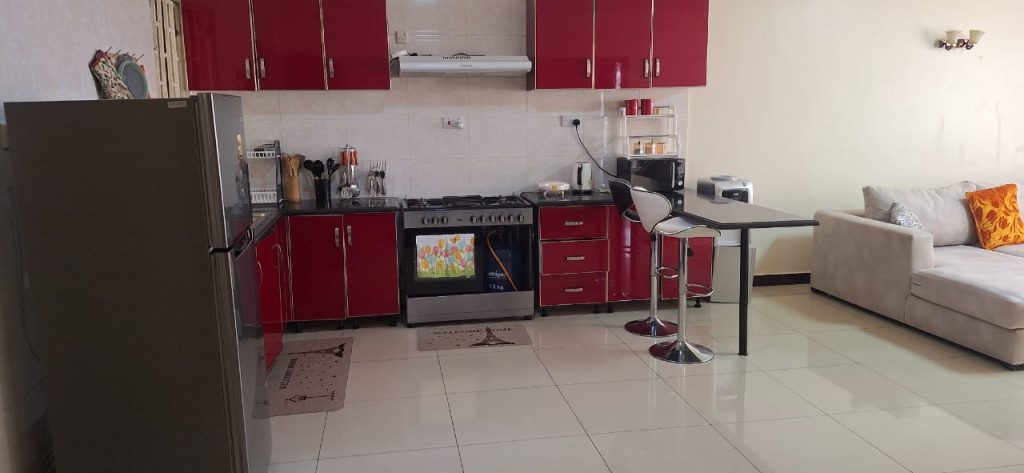 Sleek open plan kitchen with island counter setup – Luxury 3 Bedroom Serviced Apartment in Nairobi