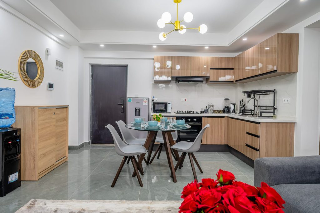 Modern dining area and the view of open plan kitchen fitted appliances - Sheva suites