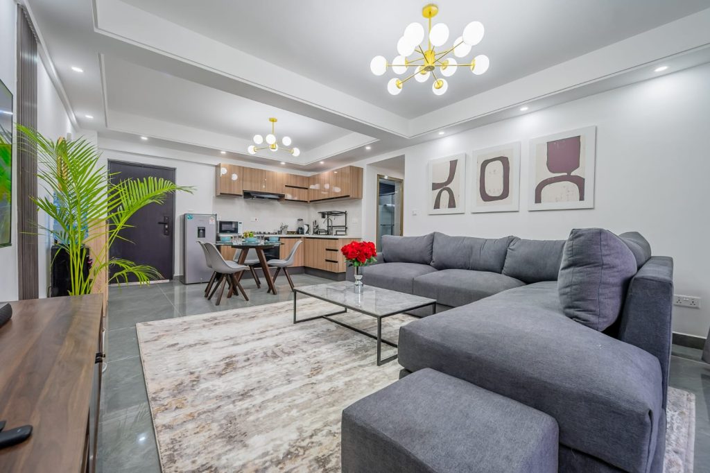 fancy interior of the sitting area and the open plan kithen at the back in Sheva suites