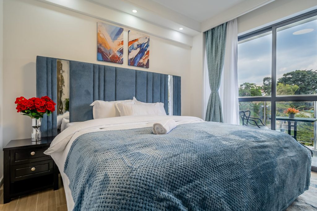 close view of the king size bed and large windows for natural lighting at sheva suits