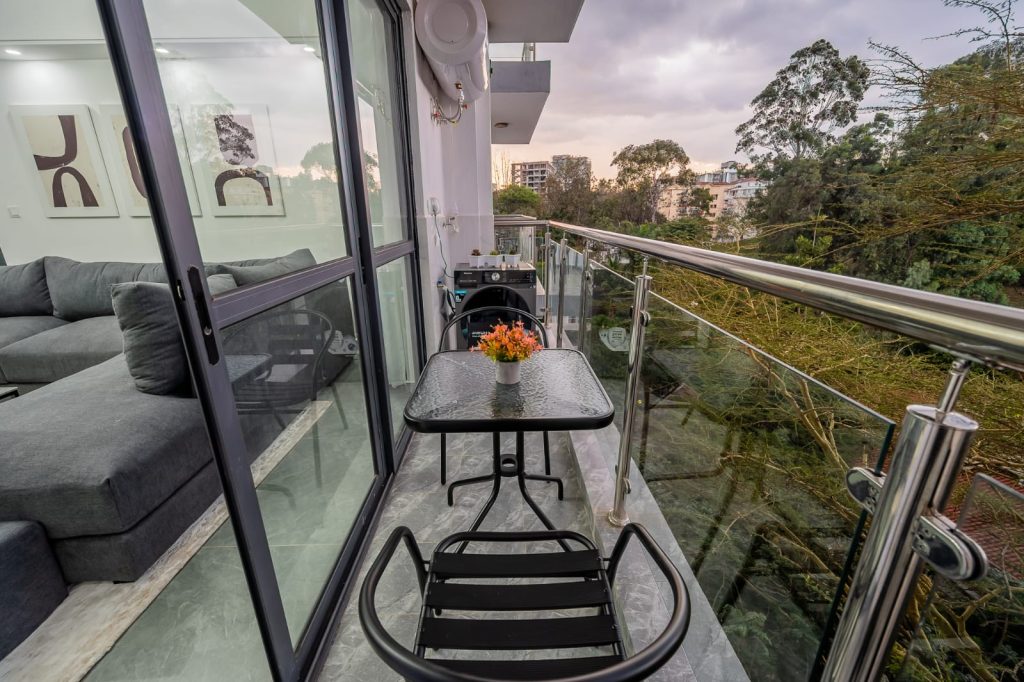 view at the balcony with 2 medium seats and a medium table at sheva suites