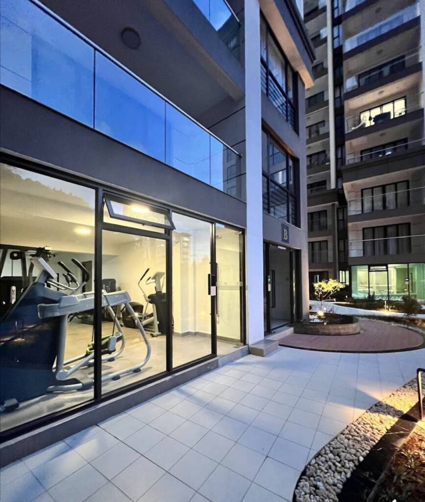 View of the fitness gym through the large sliding windsows at Furnished Apartment in Riverside Drive Area