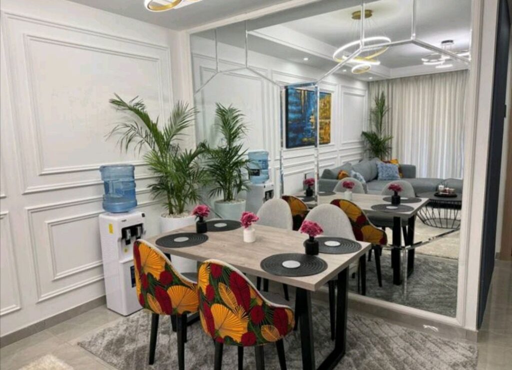 well lit lounge with sofas and a sining set for four at 108 Furnished apartment