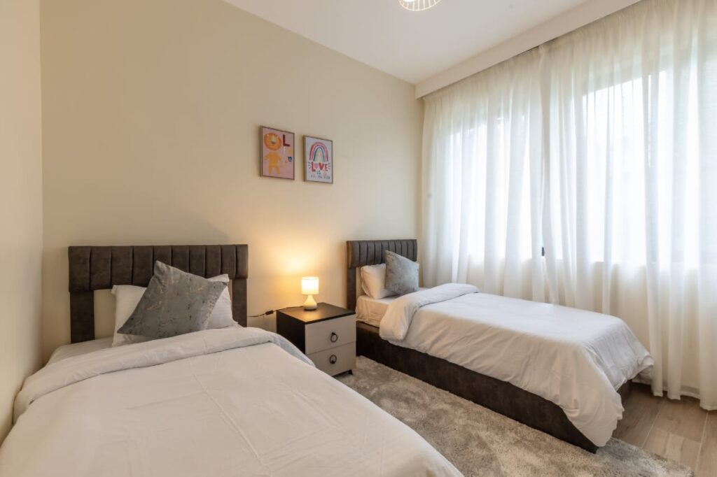 bedroom well lit with large windows at 3 bedroom apartment along General Mathenge Gardens