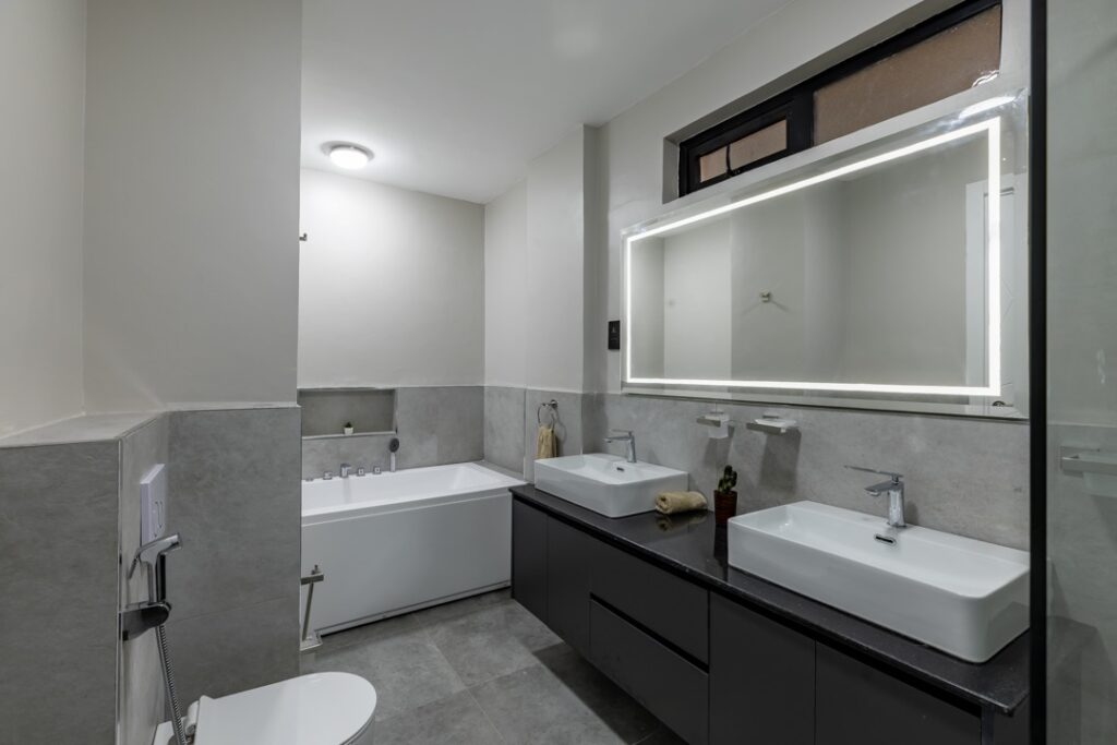 Master ensuite bathroom with his and hers sink, a a toilet and a bathtub at 3 bedroom apartment along General Mathenge Gardens