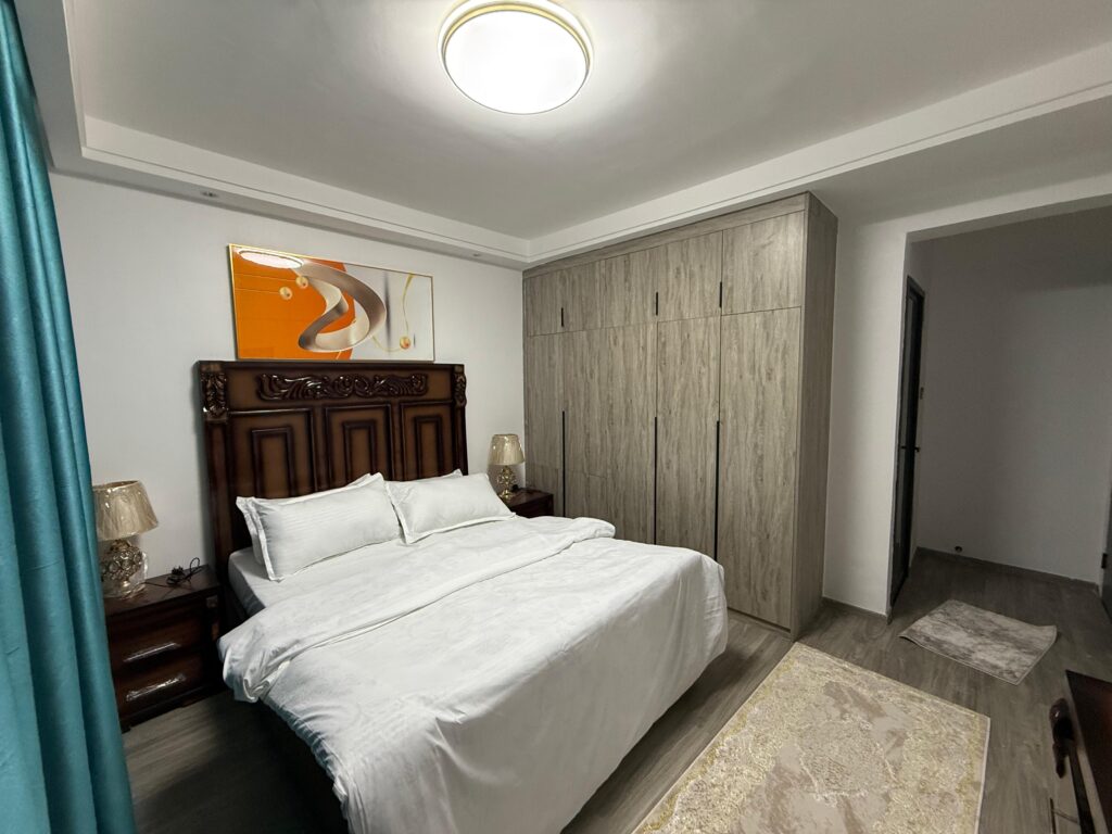 Bedroom ensuite with a king size bed and view of the fitted cabinets at Furnished Apartment at Alina Harbour Kilimani