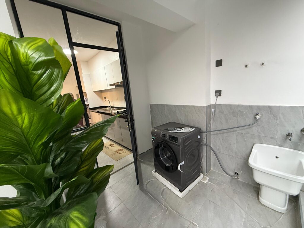 Laundry area at Furnished Apartment at Alina Harbour Kilimani with a washing machine