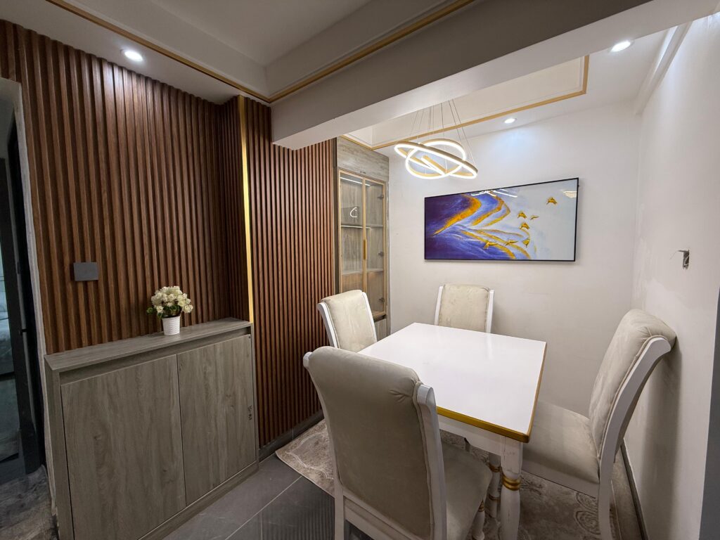 Dining area set for four with a chaandalier overhead at Furnished Apartment at Alina Harbour Kilimani