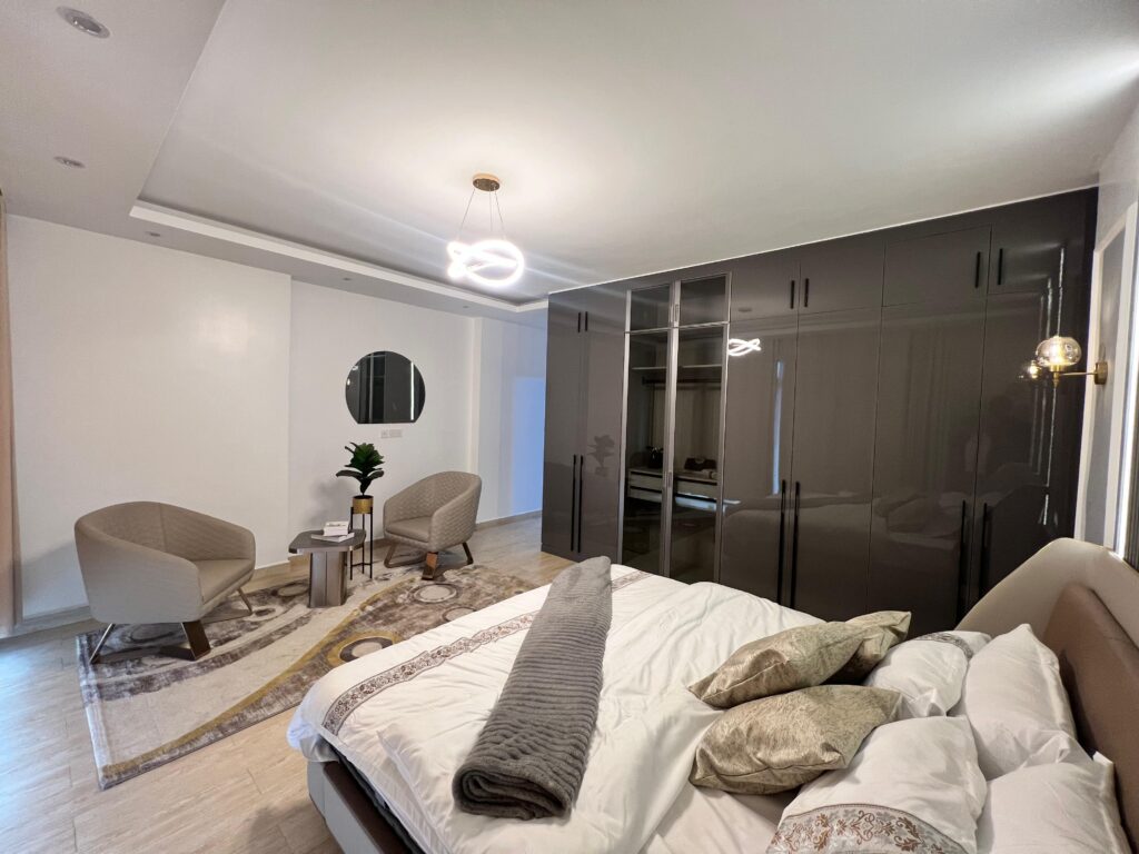expansive bedroom with modern inbuilt cabinets at Isra Residency Parklands