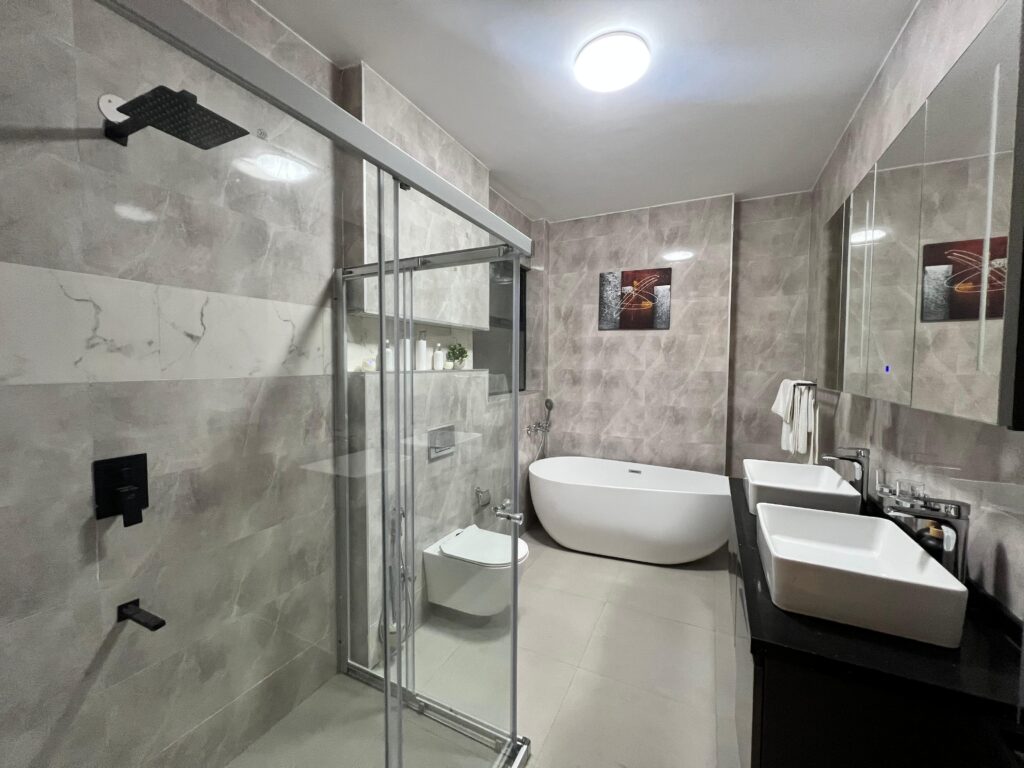 bathroom with cubicle glass shower,a bathtub and a toilet inside Isra Residency Parklands
