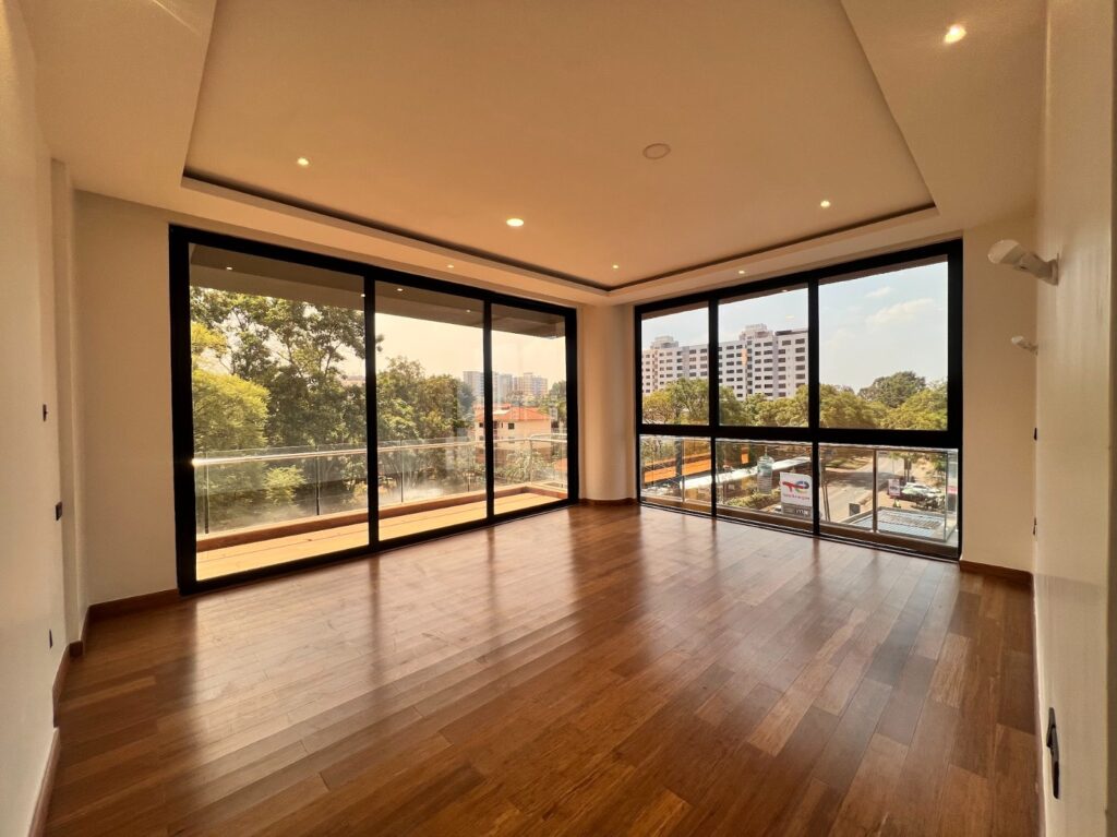 A well lit bedroom with large windows at Silver Decks Apartment