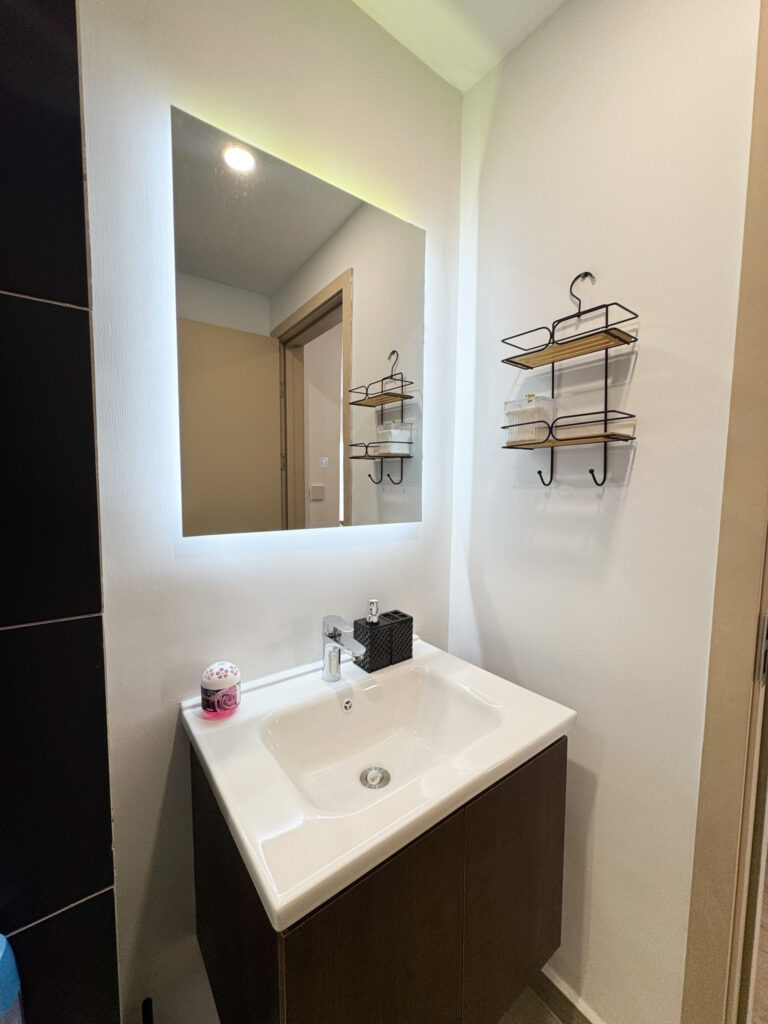 A sink with a mirror at furnished apartment at southpark apartment