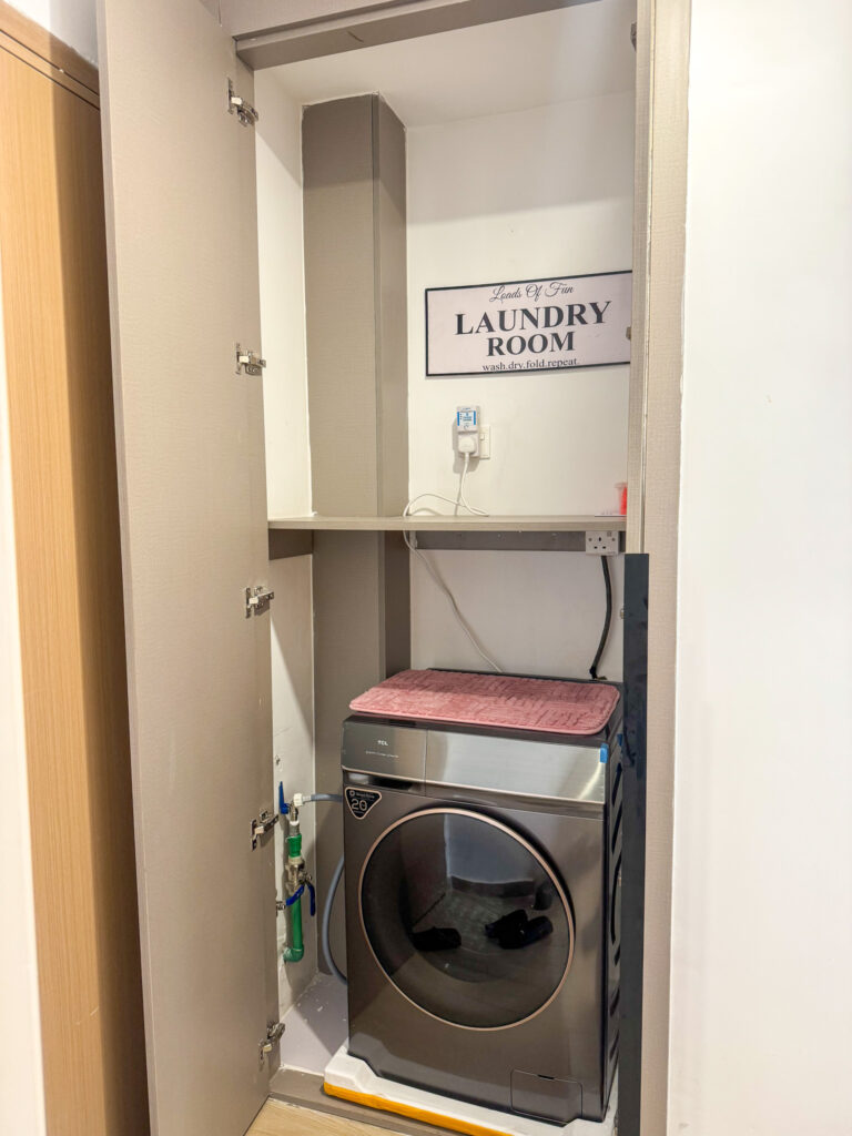 The laundry room with a washing machine at furnished apartment at southpark apartment