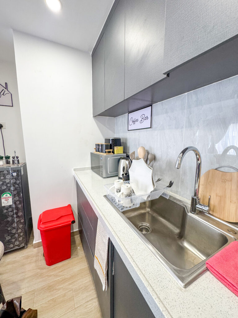 open plan kitchen fitted with a microwave,fridge,electric kettle at furnished apartment at southpark apartment