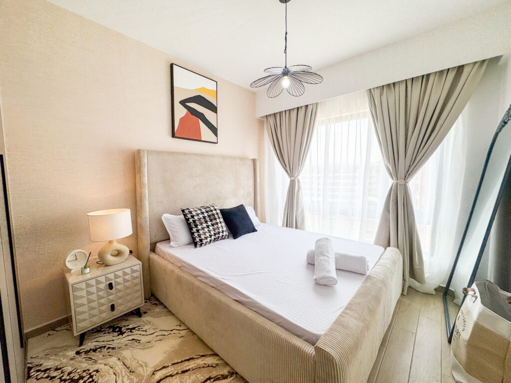 bedroom well lit with soft natural light from the large windos at furnished apartment at southpark apartment