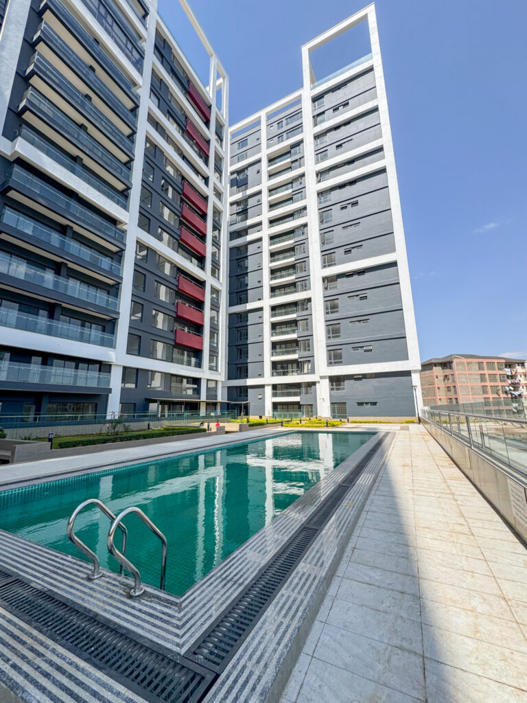 The exterior view of the swimming pool and the beautiful building at furnished apartment at southpark apartment