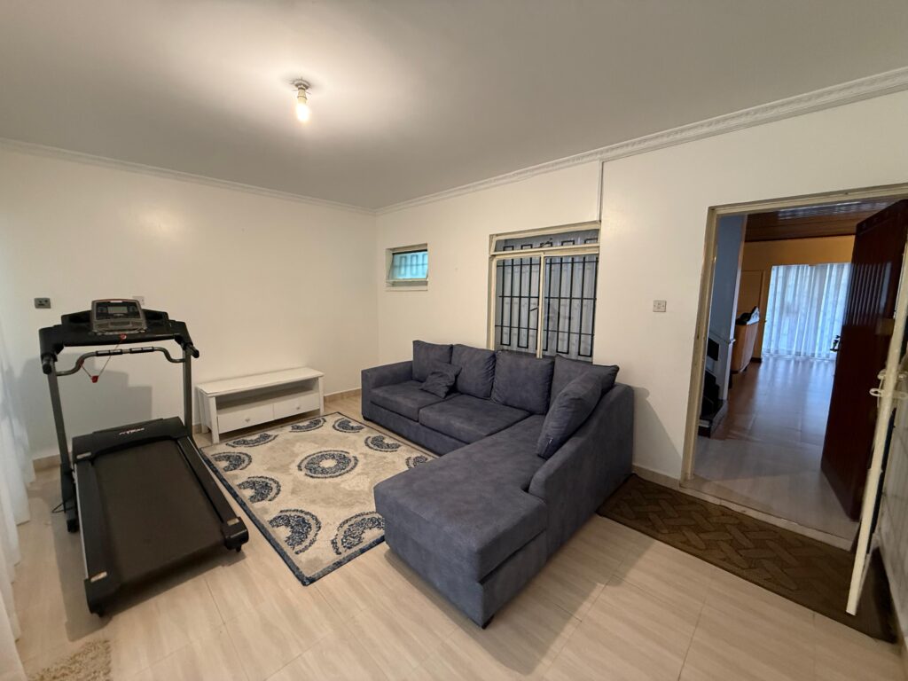 A couch in a room inside the 4 Bedroom Townhouses Along Ring Road