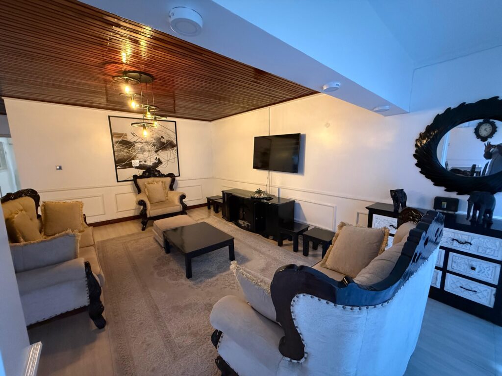 Elegant Living room with wooden ceiling panels at the 4 Bedroom Townhouses Along Ring Road