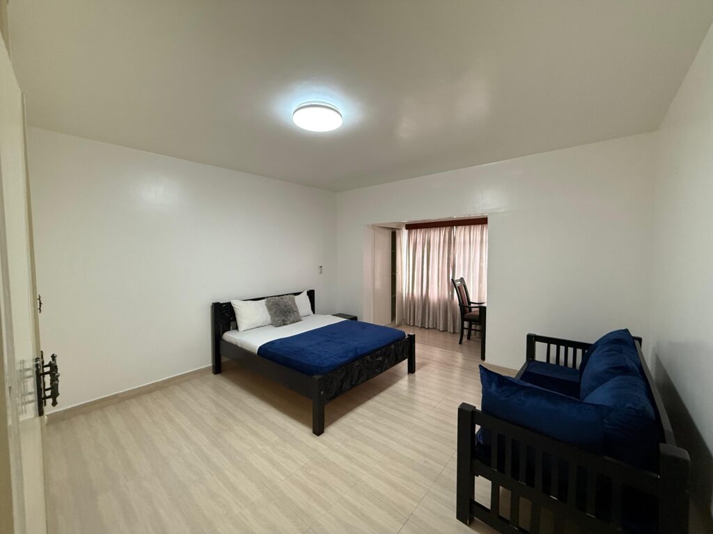 A large bedroom inside the 4 Bedroom Townhouses Along Ring Road
