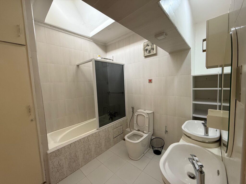 bedroom with a bathtub a toilet and a sink with cabinets at the 4 Bedroom Townhouses Along Ring Road