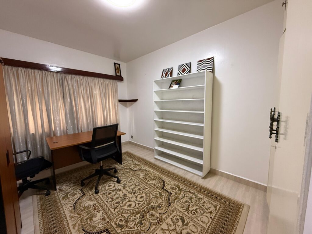 A room with a study desk and chair inside 4 Bedroom Townhouses Along Ring Road