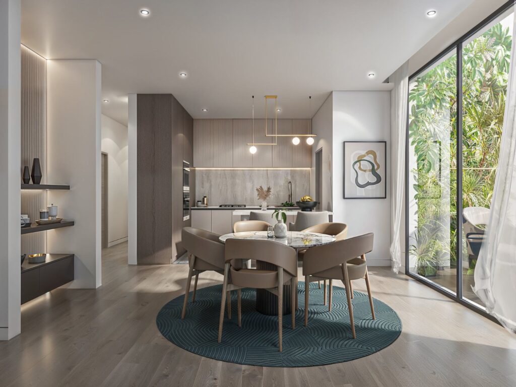 a dining area with the view of an oprn plan kitchen inside an apartment at Angani By Residency