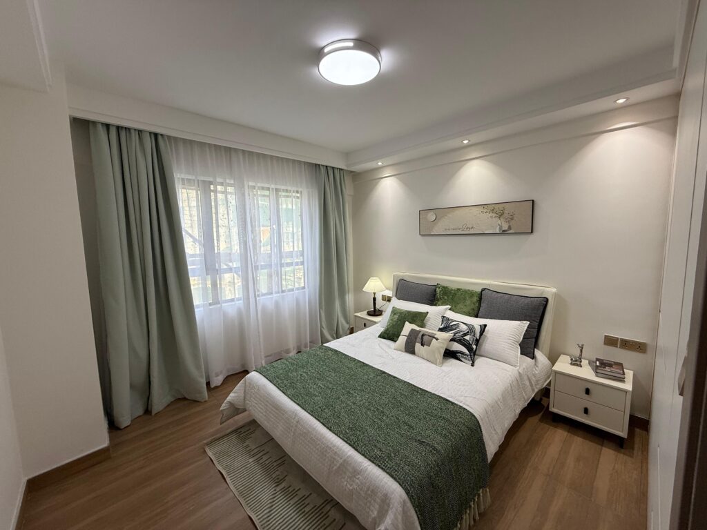 A well lit bedroom at the 1 Bedroom Apartment Near The Gateway Apartments