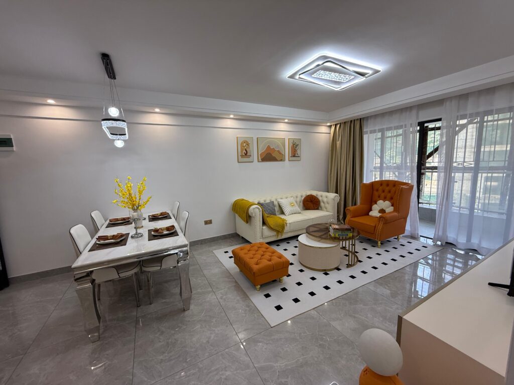 The living and the dining area with large windows and a chandelier over head at Crescent Apartment Kileleshwa 2 bedroom
