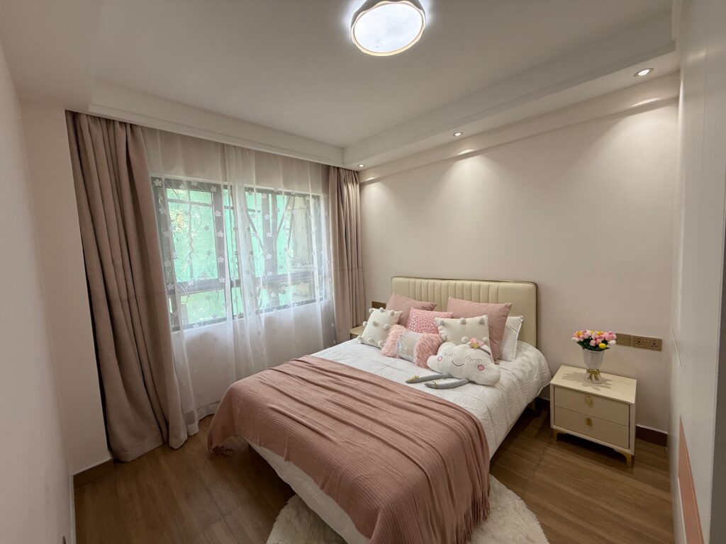 The second bedroom with large windows at Crescent Apartment Kileleshwa 2 bedroom