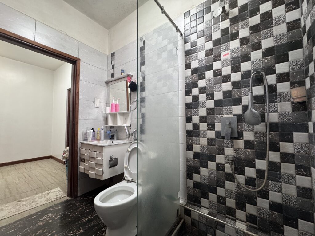 A bathroom with glass shower and a toilet at the Muthaiga Square 2 bedroom for sale by owner