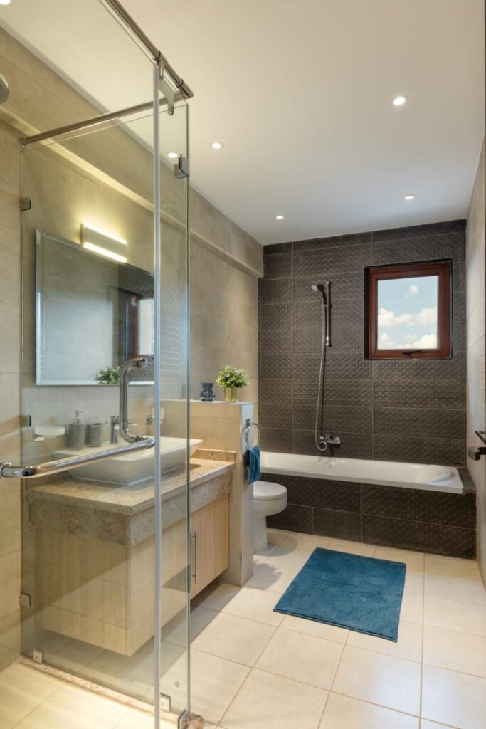 bathroom with a bathtub,shower,a toilet and a sink and mirror with storage cabinets at furnished apartment at moon valley
