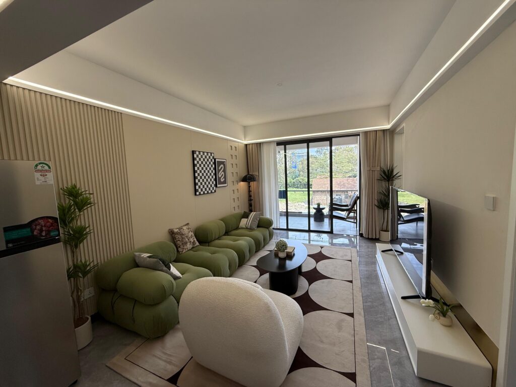 Living area with large windows at theTwo Bedroom Apartment on Wood Avenue
